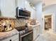Modern kitchen featuring stainless steel appliances and mosaic backsplash at 9152 Bunting Rd, Weeki Wachee, FL 34613