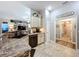 Open kitchen featuring stone counters, mosaic backsplash, stainless dishwasher, and view of living area at 9152 Bunting Rd, Weeki Wachee, FL 34613
