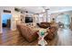 Cozy living room with hardwood floors, comfortable seating, and a decorative entertainment center at 9152 Bunting Rd, Weeki Wachee, FL 34613