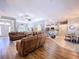 Open-concept living room with hardwood floors and seamless flow into kitchen and dining area at 9152 Bunting Rd, Weeki Wachee, FL 34613