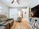 Cozy living room with wood floors, a leather recliner, and convenient storage at 9152 Bunting Rd, Weeki Wachee, FL 34613