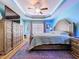 Beautiful bedroom with tray ceiling, ceiling fan, and large dresser offers style and comfort at 9152 Bunting Rd, Weeki Wachee, FL 34613