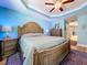 Spacious main bedroom features a tray ceiling, a ceiling fan, and an en-suite bathroom at 9152 Bunting Rd, Weeki Wachee, FL 34613