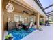 Relaxing covered patio with comfortable seating, ceiling fans, and stylish décor at 9152 Bunting Rd, Weeki Wachee, FL 34613