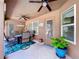 Relaxing patio area with ceiling fans, comfortable seating, and a vibrant potted plant at 9152 Bunting Rd, Weeki Wachee, FL 34613