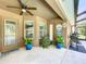 Covered patio with a ceiling fan, plants, and outdoor seating at 9152 Bunting Rd, Weeki Wachee, FL 34613