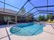 Enclosed pool with in-ground spa, surrounded by lounge seating and a patio at 9152 Bunting Rd, Weeki Wachee, FL 34613