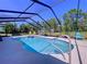 Sparkling screened-in pool with plenty of room for lounge chairs and backyard views at 9152 Bunting Rd, Weeki Wachee, FL 34613