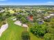 A sprawling neighborhood with golf course featuring a beautiful home with pool, lush landscaping, and mature trees at 9161 Southern Comfort Ct, Weeki Wachee, FL 34613
