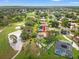 Aerial view of a beautiful home with a pool, adjacent to a golf course, surrounded by mature trees at 9161 Southern Comfort Ct, Weeki Wachee, FL 34613