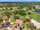 Aerial view of homes in a golf course community with lush landscaping, lake, and mature trees at 9161 Southern Comfort Ct, Weeki Wachee, FL 34613