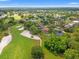 Aerial view of a golf course community with lush green lawns and mature trees at 9161 Southern Comfort Ct, Weeki Wachee, FL 34613