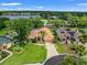Stunning aerial view of home with lush landscaping, tile roof, and lake views in a desirable community at 9161 Southern Comfort Ct, Weeki Wachee, FL 34613
