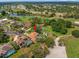 Beautiful aerial view of a residential area with a home, lush greenery, ponds, and a golf course at 9161 Southern Comfort Ct, Weeki Wachee, FL 34613