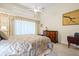 Spacious bedroom with neutral walls, light carpet, tray ceiling, and light-blocking draperies at 9161 Southern Comfort Ct, Weeki Wachee, FL 34613