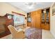 Comfortable bedroom featuring built-in shelving, cabinets, and a large rug at 9161 Southern Comfort Ct, Weeki Wachee, FL 34613