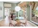 A bright breakfast nook with a glass table and view of the patio and backyard at 9161 Southern Comfort Ct, Weeki Wachee, FL 34613