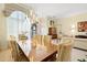 Open-concept dining room with large windows, modern chandelier, neutral tones, and access to the living space at 9161 Southern Comfort Ct, Weeki Wachee, FL 34613