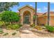 Close up of the front door and walkway surrounded by lush landscaping creating a private entry at 9161 Southern Comfort Ct, Weeki Wachee, FL 34613