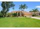Beautiful home with lush green lawn, elegant arched entryway, and perfectly manicured landscaping at 9161 Southern Comfort Ct, Weeki Wachee, FL 34613