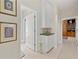 Bright hallway with white cabinets and a view into the stylish bathroom at 9161 Southern Comfort Ct, Weeki Wachee, FL 34613