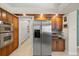 Gourmet kitchen featuring stainless steel appliances and custom cabinetry at 9161 Southern Comfort Ct, Weeki Wachee, FL 34613