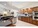Spacious kitchen featuring ample wood cabinetry, granite counters, and stainless steel appliances at 9161 Southern Comfort Ct, Weeki Wachee, FL 34613