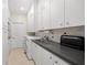 Well-equipped laundry room with modern appliances, ample counter space, and lots of storage at 9161 Southern Comfort Ct, Weeki Wachee, FL 34613