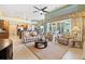 Open-concept living room featuring neutral decor, tile flooring, and sliding glass doors to lanai at 9161 Southern Comfort Ct, Weeki Wachee, FL 34613