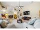 Open living room with a fireplace, built-in shelving, and a vintage jukebox at 9161 Southern Comfort Ct, Weeki Wachee, FL 34613