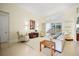 Bright living room with white furnishings and a view of the outdoor pool at 9161 Southern Comfort Ct, Weeki Wachee, FL 34613
