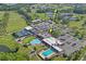 An aerial view of the community club house, tennis courts, and pool at 9622 Brassie Ct # 9, New Port Richey, FL 34655