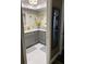 Updated bathroom with gray cabinetry, white countertops, and decorative mirror at 9622 Brassie Ct # 9, New Port Richey, FL 34655
