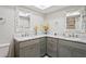 Bathroom with double vanity, marble countertops, and ornate mirrors at 9622 Brassie Ct # 9, New Port Richey, FL 34655