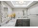 Bathroom featuring marble countertops, decorative mirrors, and a skylight at 9622 Brassie Ct # 9, New Port Richey, FL 34655