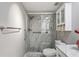 Bathroom featuring a glass shower with gray tiling, and updated cabinetry at 9622 Brassie Ct # 9, New Port Richey, FL 34655
