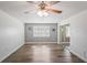 An airy bedroom with wood-look flooring, ceiling fan, and sliding glass doors for lots of light at 9622 Brassie Ct # 9, New Port Richey, FL 34655