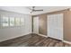 Comfortable bedroom with ceiling fan, wood-look flooring, and large closet at 9622 Brassie Ct # 9, New Port Richey, FL 34655