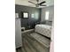 Cozy bedroom with dark accent wall, wood floors, and shuttered window for natural light at 9622 Brassie Ct # 9, New Port Richey, FL 34655