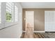 Neutral bedroom features wood-look flooring, closet, and modern plantation shutters at 9622 Brassie Ct # 9, New Port Richey, FL 34655