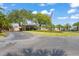 Welcoming property entrance with mature trees, manicured lawn, and an American flag at 9622 Brassie Ct # 9, New Port Richey, FL 34655