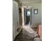 Hallway that leads to a bathroom, bedroom, and kitchen with dark wood-look floors at 9622 Brassie Ct # 9, New Port Richey, FL 34655