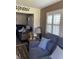 Cozy living room with wood floors, plantation shutters, and a comfortable blue sofa at 9622 Brassie Ct # 9, New Port Richey, FL 34655