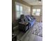 Cozy living room with a comfortable blue sofa, plantation shutters, and stylish decor at 9622 Brassie Ct # 9, New Port Richey, FL 34655