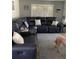 Comfortable living room with a plush sectional sofa and natural light from shuttered windows at 9622 Brassie Ct # 9, New Port Richey, FL 34655
