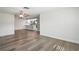 Open-concept living space with wood-look floors, ceiling fans, and modern kitchen views at 9622 Brassie Ct # 9, New Port Richey, FL 34655