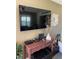 Living room with large flatscreen TV and stylish decor on a wooden console table at 9622 Brassie Ct # 9, New Port Richey, FL 34655