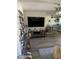 Open concept living and dining area with a large TV and wood-look floors at 9622 Brassie Ct # 9, New Port Richey, FL 34655