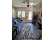 Bright and airy living room with a comfy blue sofa, shutters, and access to the outdoors at 9622 Brassie Ct # 9, New Port Richey, FL 34655