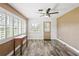 Cozy room with a ceiling fan, wood flooring, and natural light from large windows at 9622 Brassie Ct # 9, New Port Richey, FL 34655